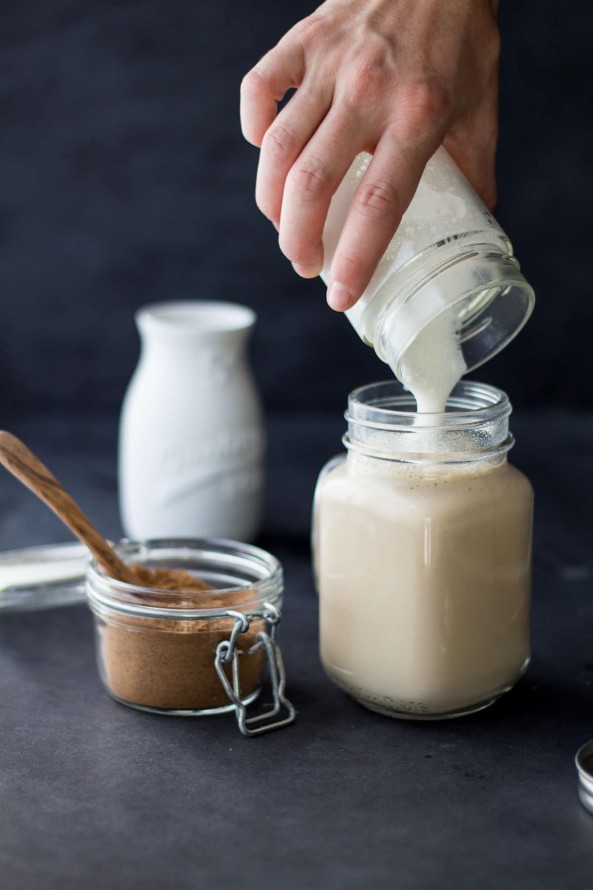 Adding frothed milk to chai spice tea for a delicious homemade chai latte.