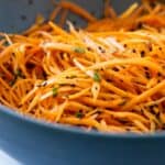 Carrot salad in a blue salad bowl.