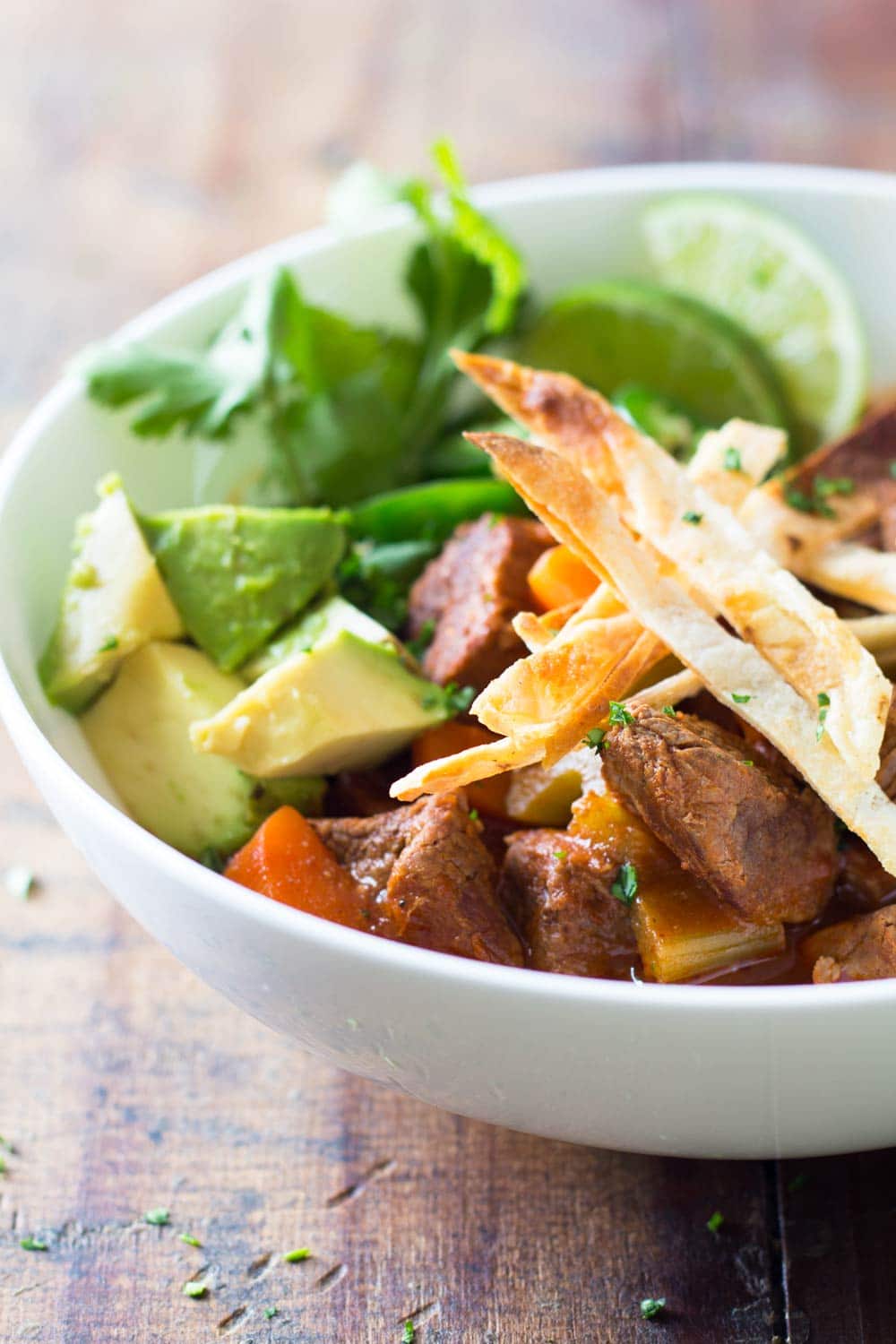 Mexican beef stew with avocado, jalapeño, tortilla chikps and lime.