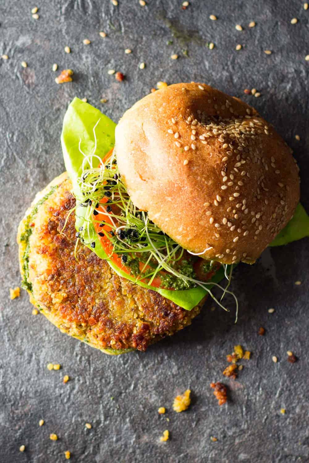 Top view of quinoa burger with top of bun set aside to show ingredients. 