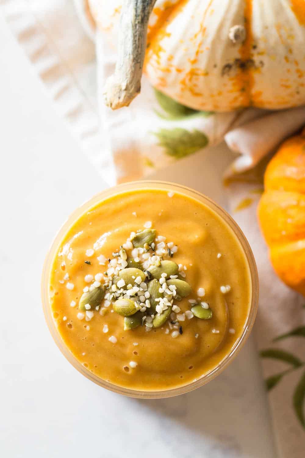 top down view of pumpkin smoothie topped with seeds